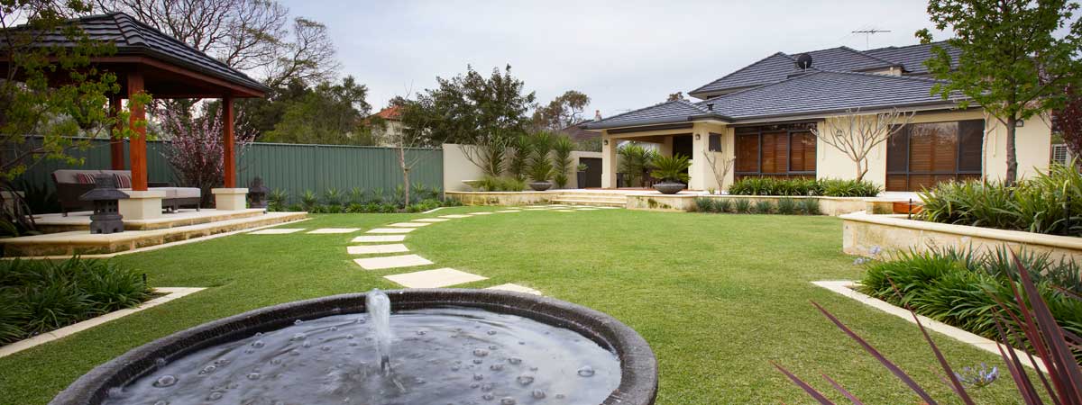 An inner cityscape with undulating lawns and stainless steel handrails