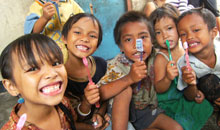 Kids holding toothbrushes